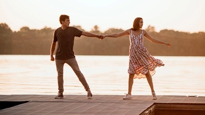 Pareja joven bailando al atardecer