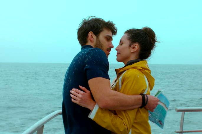 Pareja besándose en un barco.